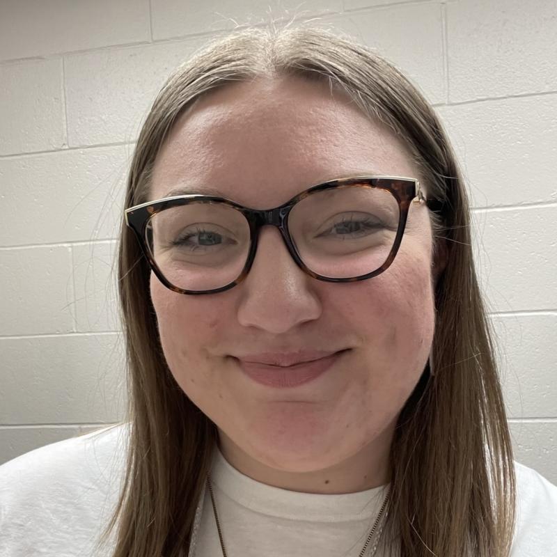 woman with brown hair and glasses