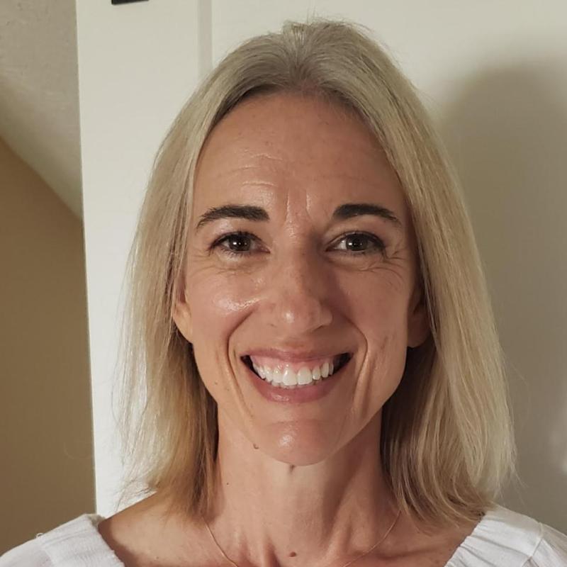 woman in white shirt smiling 