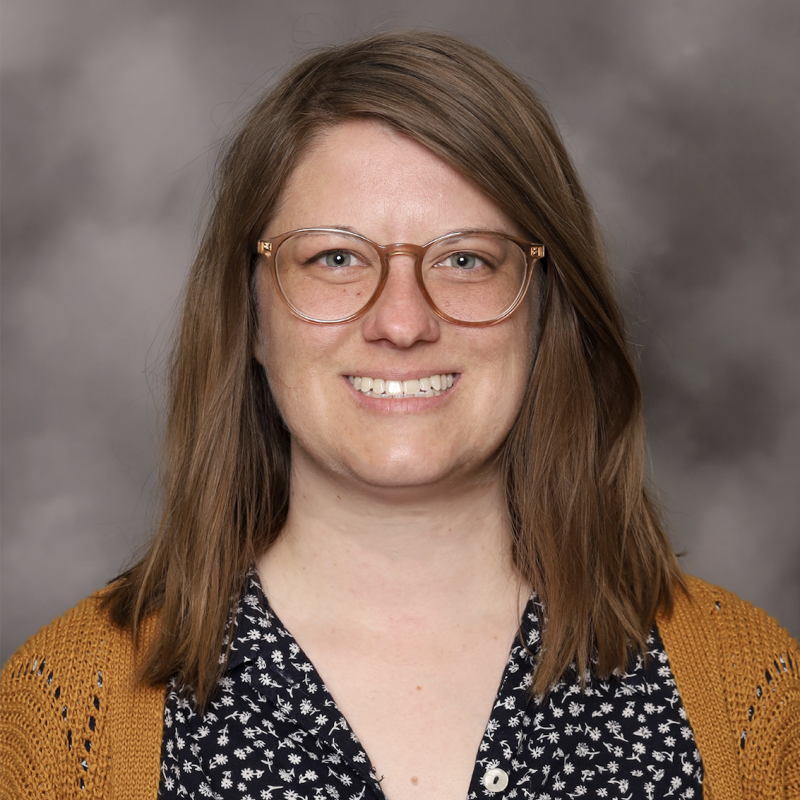 woman with glasses and brown hair smiling